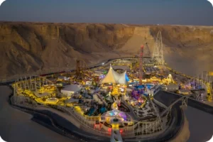 Six Flags Qiddiya City illuminated during an evening visit