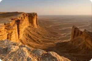 Visitor overlooking the sandstone cliffs at the Edge of the World Saudi Arabia