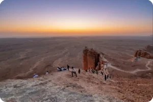 Travelers watching sunset during an Edge of the World Riyadh tour