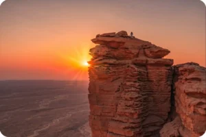 Rock formation illuminated by sunset at the Edge of the World Riyadh