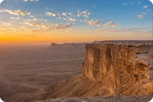 Golden sunset over rugged cliffs during an Edge of the World tour