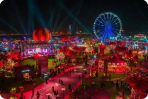 Colourful illuminated gardens and a Ferris wheel at Wonder Garden at night.