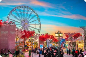 Ferris wheel and colourful outdoor attractions at Wonder Garden at sunset.